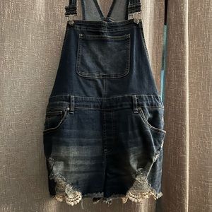Distressed overalls with lace embellishments on legs